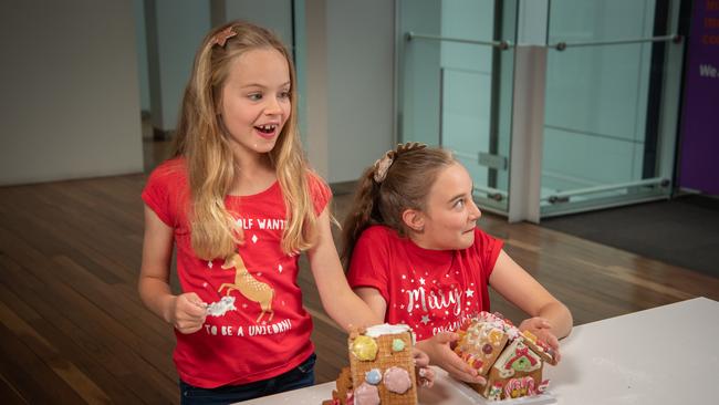 Sisters Ruby and Lilly Schipper, the moment before the Woolworths house collapsed. Picture: Brad Fleet