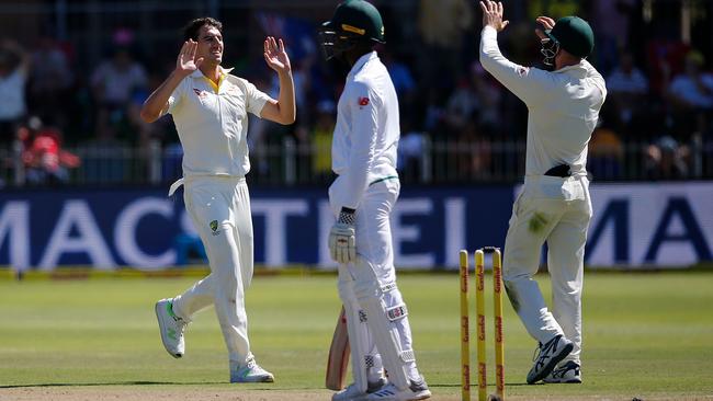 Pat Cummins, left, celebrates the wicket of Kagiso Rabada. Picture: AFP