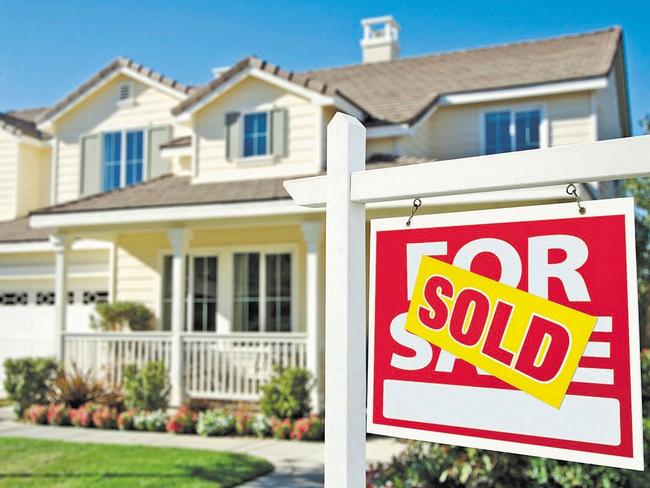 Sold Home For Sale Sign in Front of Beautiful New House.