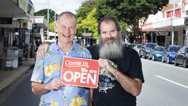 Stones Corner shops are pushing that they are still open for business as usual. Our Stones Corner president Michael Weibler and owner of Sonic Sherpa Simon Homer. (AAP Image/Renae Droop)