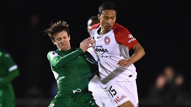 Trent Clulow of Bentleigh Greens (left) and Kearny Baccus of the Wanderers compete for the ball during their FFA Cup clash on Tuesday night.
