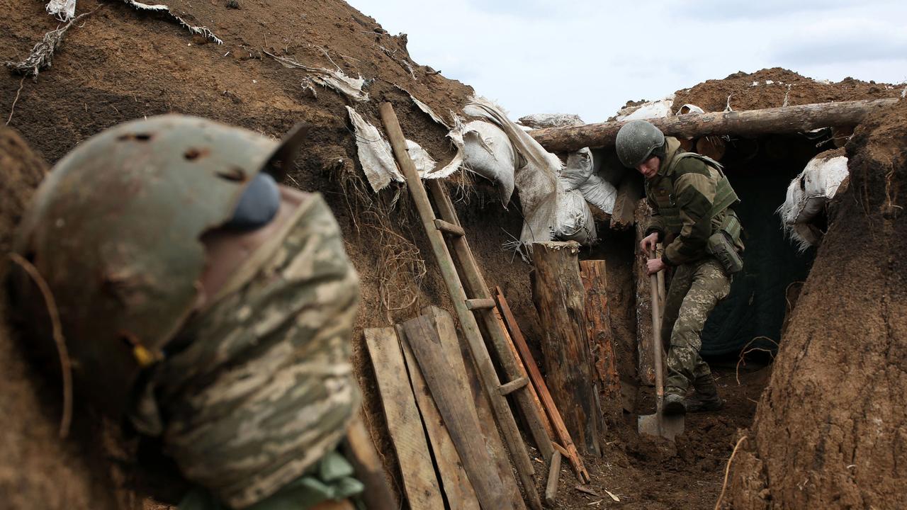 An Ukrainian serviceman digs the ground of a trench on the frontline near the town of Zolote, in the Lugansk region. Picture: AFP