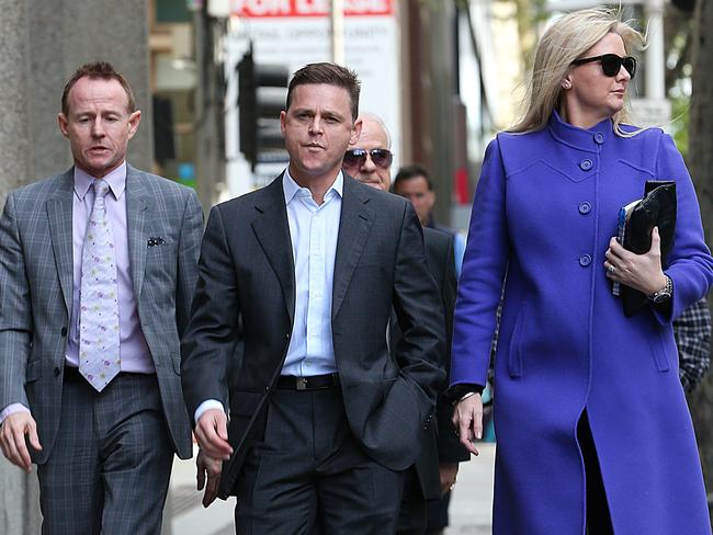 Banned jockey Danny Nikolic (centre) arrives at VCAT to try and get his ban overturned. Picture: Ian Currie
