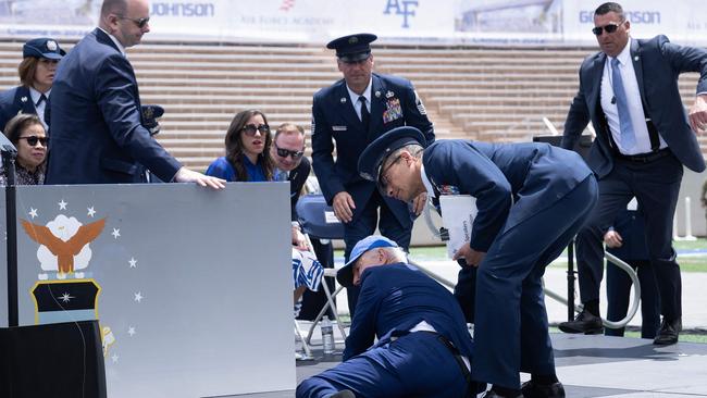 Joe Biden is helped up after falling during the graduation ceremony at the United States Air Force Academy in Colorado. Picture: AFP.