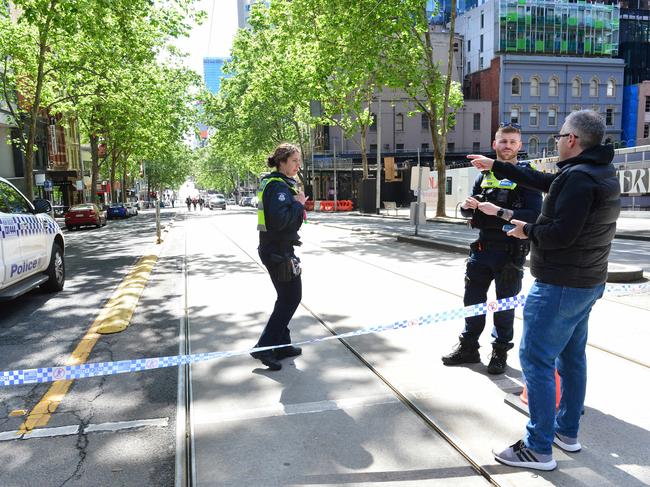 A man talks with police at the cordoned off scene. Picture: Nicki Connolly