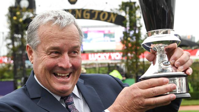 Trainer Gordon Richards shows off the spoils of victory. Picture: AAP