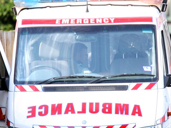 Siege in Garfield. Paramedics treat the man in the back of an ambulance before taking him away. Picture: Hamilton Fiona