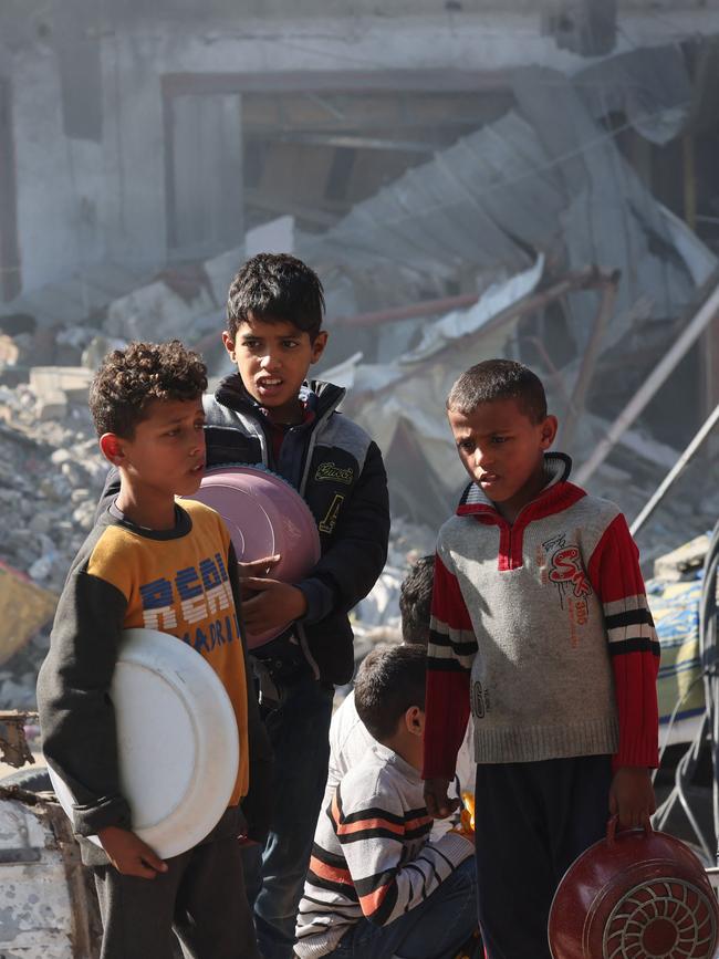 Displaced Palestinian children queue for food and bread in Rafah, on November 30 Picture: Mohammed Abed/AFP