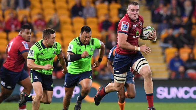 Reds star Izack Rodda tries to burst away from his Highlanders opponents last season. Picture: AAP Image/Dave Hunt