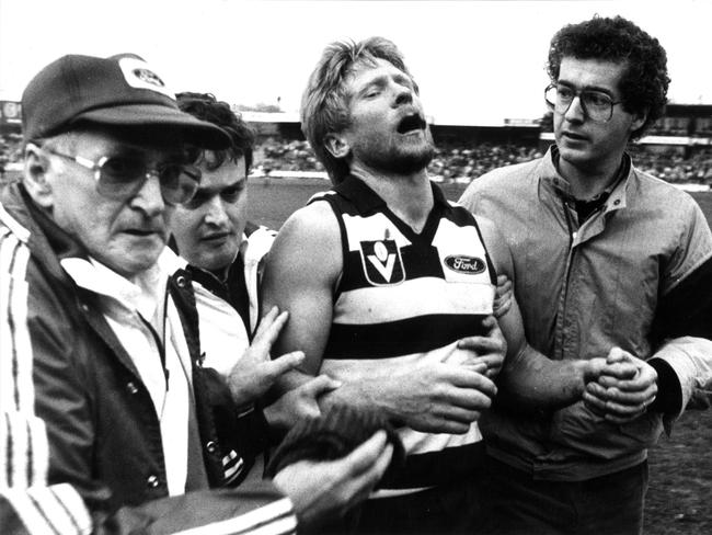 Cat Neville Bruns was left worse for wear after he was whacked by Hawks hard man Leigh Matthews. Picture: Mike Dugdale