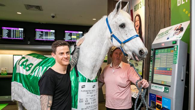 Nick Hall escorts Subzero through an inner city TAB outlet as he places $200 on Hall’s Cup ride Jameka. Hall says “Subbie” is the first horse he sat on. Nick’s father Greg won the 1992 Melbourne Cup on Subzero.