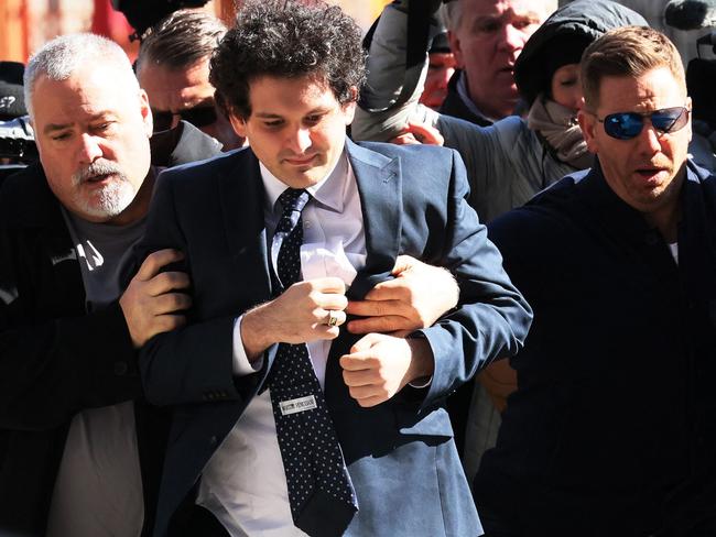 NEW YORK, NEW YORK - MARCH 30: (EDITOR'S NOTE: Alternate crop) FTX Founder Sam Bankman-Fried arrives at Manhattan Federal Court for a court appearance on March 30, 2023 in New York City. A revised indictment was filed in federal court accusing Bankman-Fried of paying a $40 million bribe to one or more Chinese government officials. He has already been charged with eight criminal counts of fraud, conspiracy, and money-laundering offenses which include making illegal political contributions.   Michael M. Santiago/Getty Images/AFP (Photo by Michael M. Santiago / GETTY IMAGES NORTH AMERICA / Getty Images via AFP)