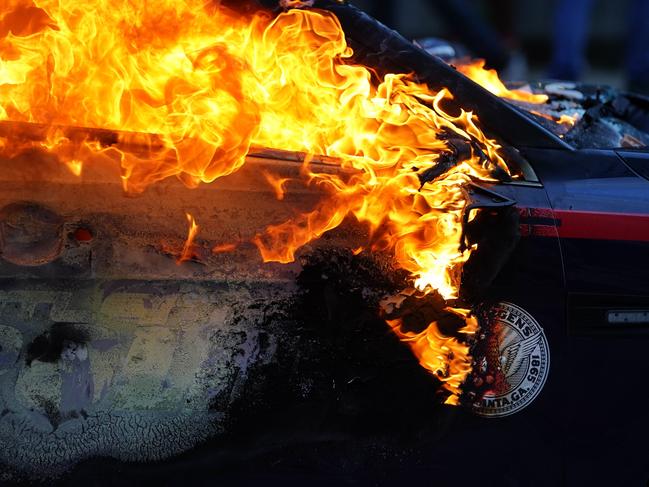 A burning police car is seen during a protest in Atlanta, Georgia. Picture: Getty