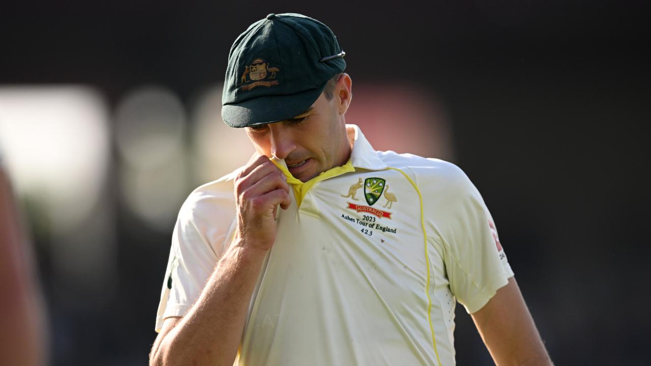 Australia captain Pat Cummins leaves the field after a tough day at Old Trafford. Getty Images