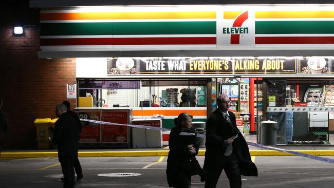 Police at the 7-Eleven service station in Springvale South, where a worker was shot this morning. Picture: David Crosling