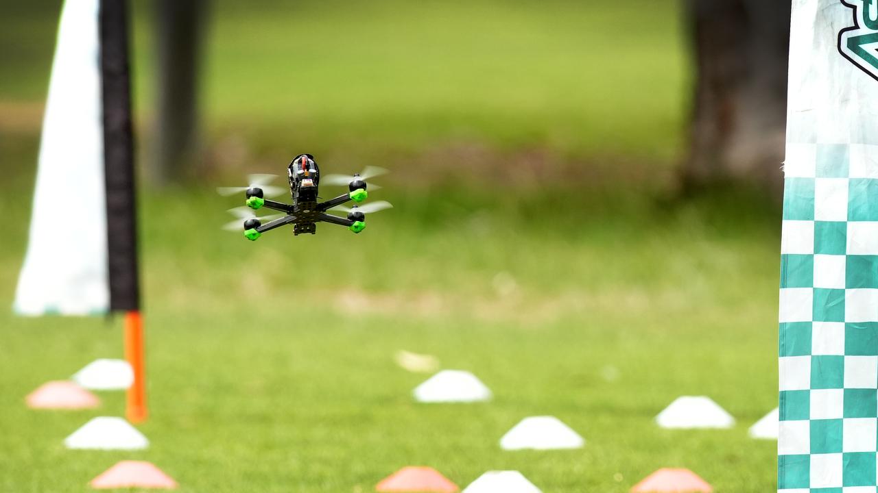 Drone racing enthusiasts test their skill racing through a course of gates. Picture: Dean Martin