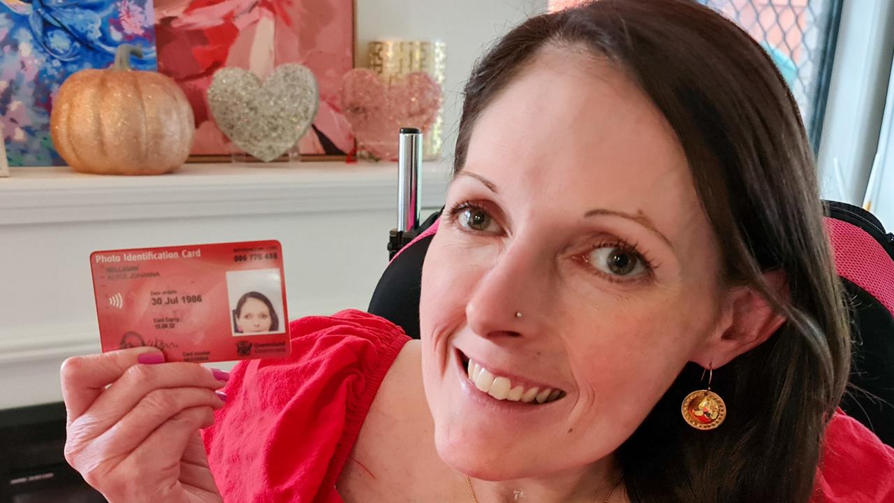 Toowoomba disability advocate Alyce Nelligan holding her botched identification card due to the fixed-camera system used by the Department of Transport and Main Roads.