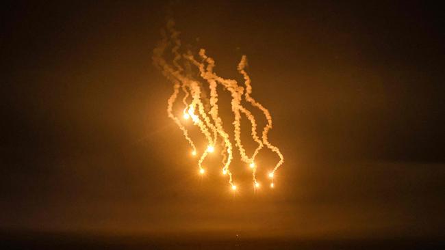 A picture taken from Rafah shows flares lighting the skies over Khan Yunis in the southern Gaza Strip during Israeli strikes. Picture: AFP