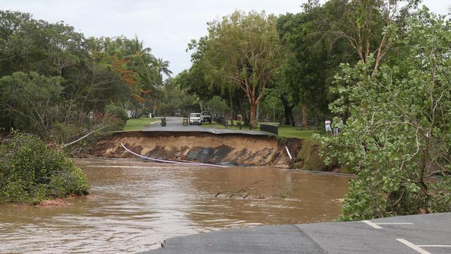 A huge section of Casuarina St at Holloways Beach has been swept away by the torrent that tore through the Cairns suburb on Sunday. Picture: Peter Carruthers