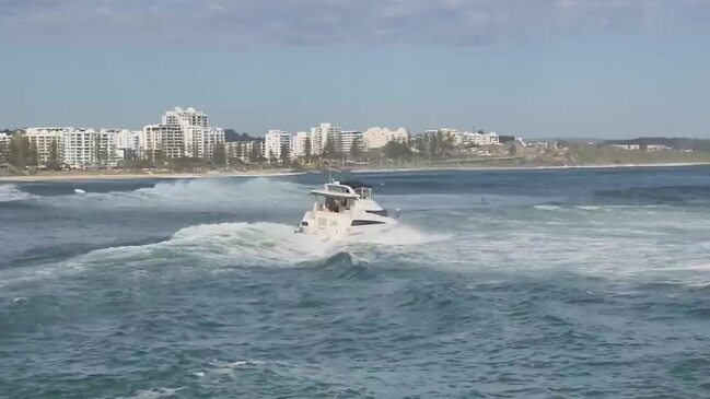 A boat crosses the Mooloolah River mouth at the Mooloolaba Spit