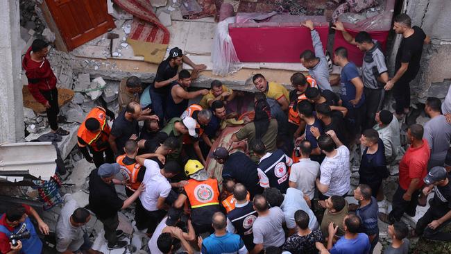 Rescuers remove people from under the rubble of a house destroyed by an Israeli air strike in Rafah in the southern Gaza Strip. Picture: AFP