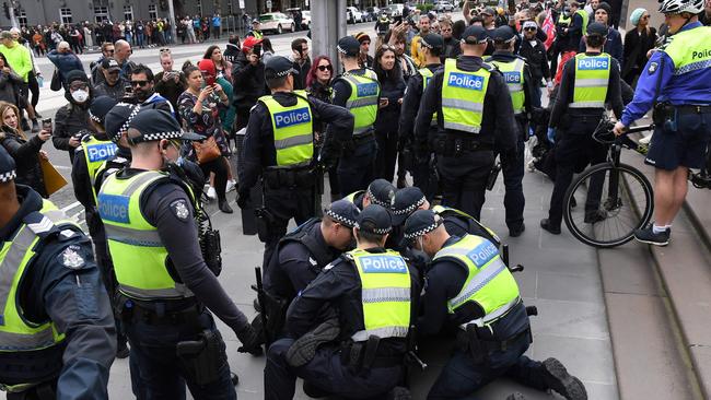 Police detain an anti-lockdown protester on the steps of the Victorian parliament. Picture: AFP