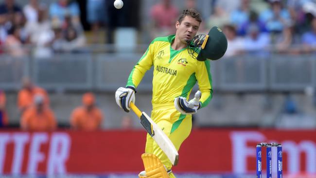 Alex Carey copped one — but still had the presence of mind to catch his helmet as it ploughed towards the wickets. Pic: AFP