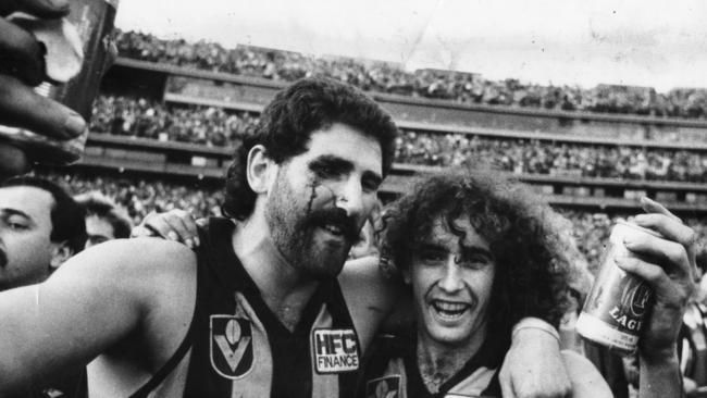 The move harks back to the days of the VFL. Footballer Robert DiPierdomenico and John Platten celebrating the 1986 Grand Final at the MCG. Picture: Stuart Hannagan