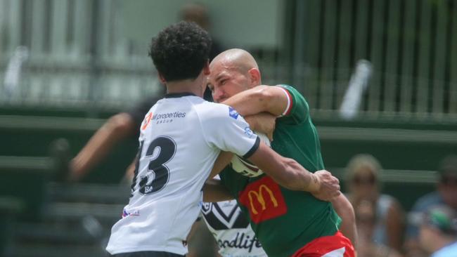 Souths Logan's Kahmarley Faaaoga-Andrew has his hands full trying to contain Christian Rivers.