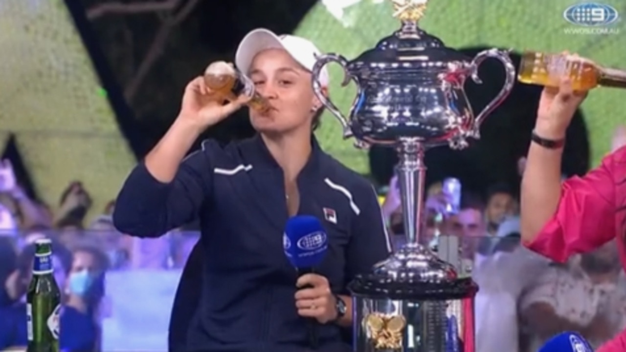 Ash Barty celebrates her 2022 Australian Open win with a beer during an interview on Channel 9. Picture: Supplied