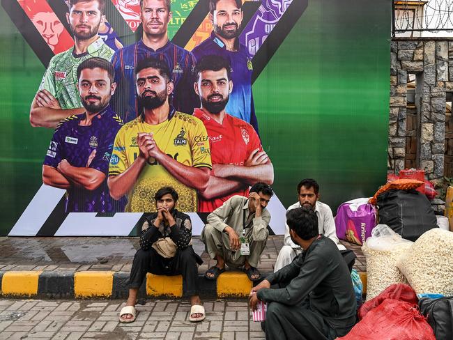 Vendors pack their belongings as they leave Rawalpindi Cricket Stadium following the postponement of the Pakistan Super League. Picture: AFP