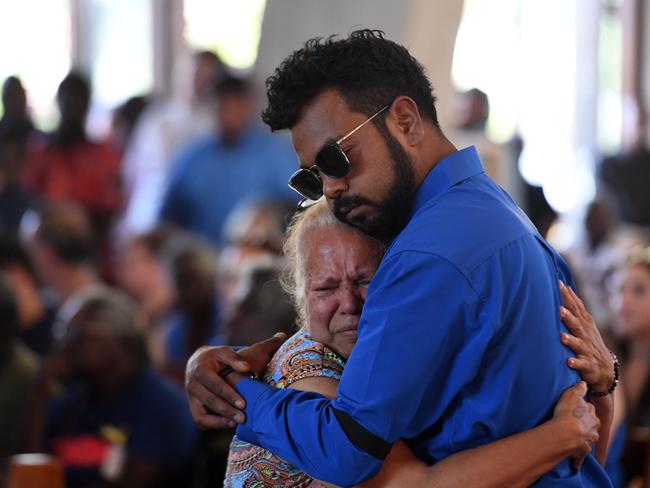 Junior Rioli consoles a relative at his father's funeral service. Picture: (A)manda Parkinson