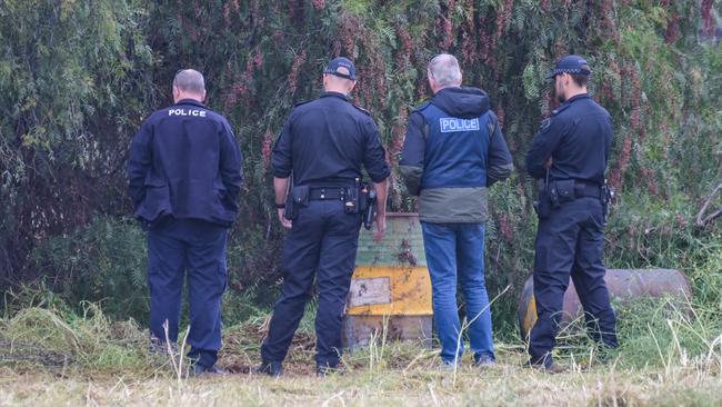 Police search through trees in a vacant paddock on Cheviot Rd in Salisbury South where the decomposed body was found. Picture: Brenton Edwards