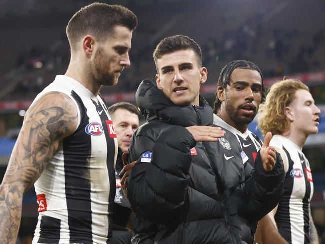 MELBOURNE, AUSTRALIA - AUGUST 05: Nick Daicos of the Magpies (C) walks off the field with Jeremy Howe (L) and Isaac Quaynor of the Magpies (2R) as Magpies head coach Craig McRae (L2) looks on during the round 21 AFL match between Hawthorn Hawks and Collingwood Magpies at Melbourne Cricket Ground, on August 05, 2023, in Melbourne, Australia. (Photo by Daniel Pockett/Getty Images)