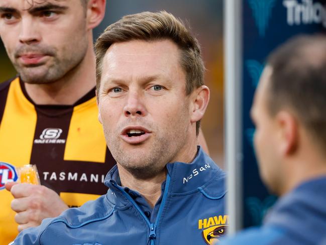 MELBOURNE, AUSTRALIA - AUGUST 20: Sam Mitchell, Senior Coach of the Hawks addresses his players during the 2023 AFL Round 23 match between the Melbourne Demons and the Hawthorn Hawks at Melbourne Cricket Ground on August 20, 2023 in Melbourne, Australia. (Photo by Dylan Burns/AFL Photos via Getty Images)