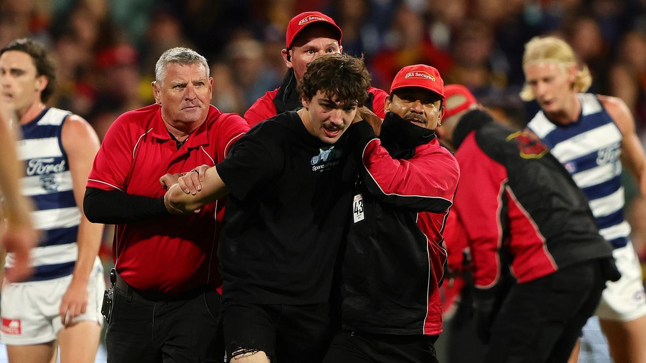 Security escorts Saginario from Adelaide Oval. Picture: Sarah Reed/AFL Photos