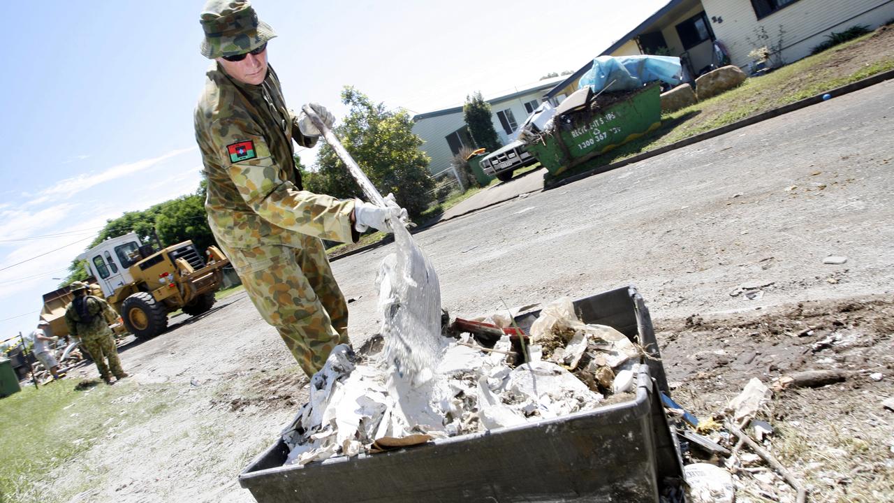 Sgt Richard Lovell helps out in Logan Street in North Booval. Photo: Claudia Baxter / The Queensland Times