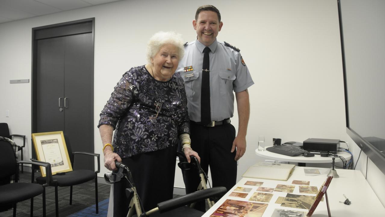 The Queensland Ambulance Service paid tribute to Enid Machin for 50 years of service on the Ipswich Ambulance Committee. She stands next to West Moreton District Director Superintendent Drew Hebbron.