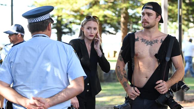 Reporter Eliza Barr and photographer Dylan Robinson talk with police after the alleged assault. Picture: Joel Carrett