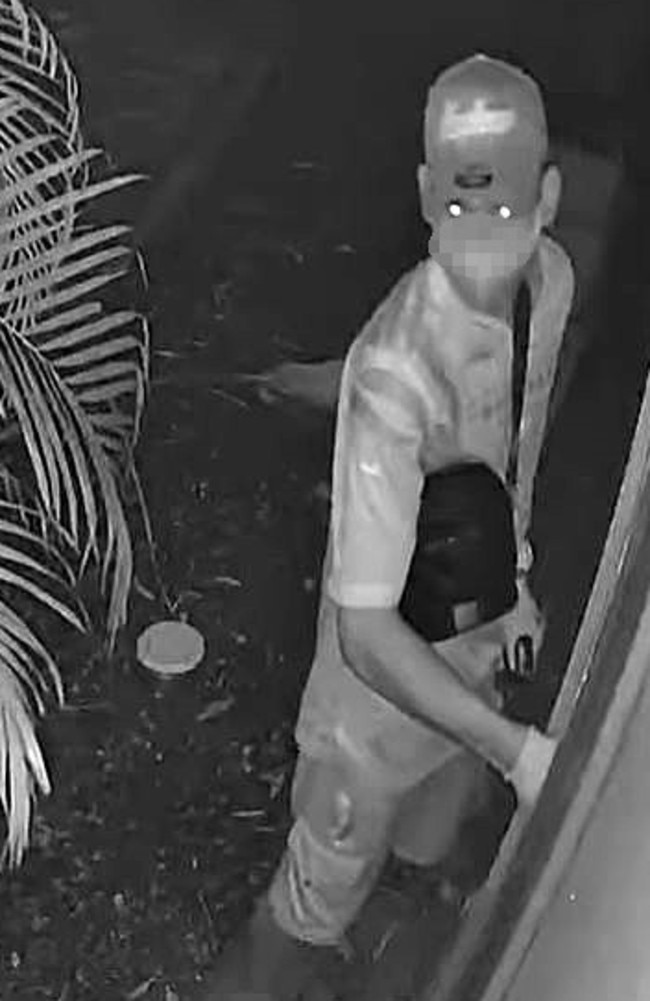 CCTV shows masked intruder in a No. 9 jersey using a lighter to break in through a window as the family sleeps inside.