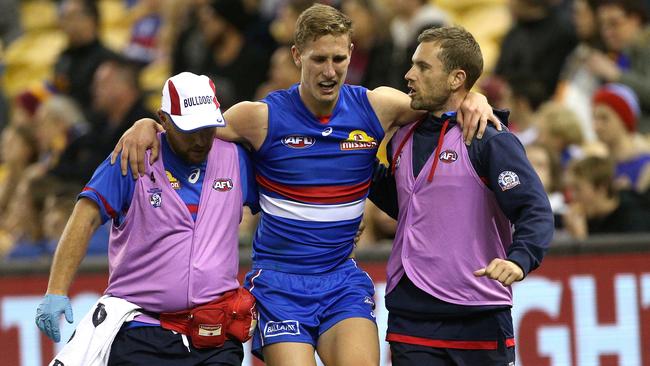 Aaron Naughton is helped from the field. Picture: AAP Images