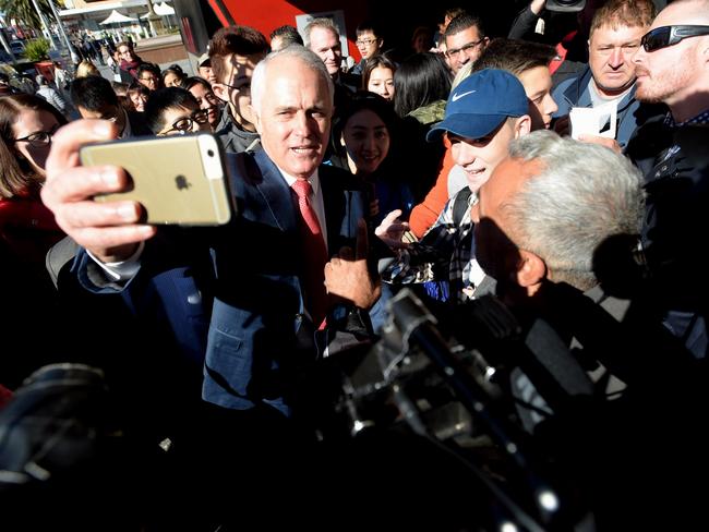 Australian Prime Minister Malcolm Turnbull takes selfies with locals during a street walk ahead of arriving at the Sunny Harbour Yum Cha in the federal seat of Barton in the Sydney suburb of Hurstville. A federal election will be held in Australia on Saturday July 2. (AAP Image/Lukas Coch)