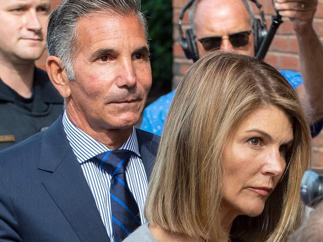 Actress Lori Loughlin (R) and husband Mossimo Giannulli exit the Boston Federal Court house after a pre-trial hearing with Magistrate Judge Kelley at the John Joseph Moakley US Courthouse in Boston on August 27, 2019. - Loughlin and Giannulli are charged with conspiracy to commit mail and wire fraud and conspiracy to commit money laundering in the college admissions scandal. (Photo by Joseph Prezioso / AFP)