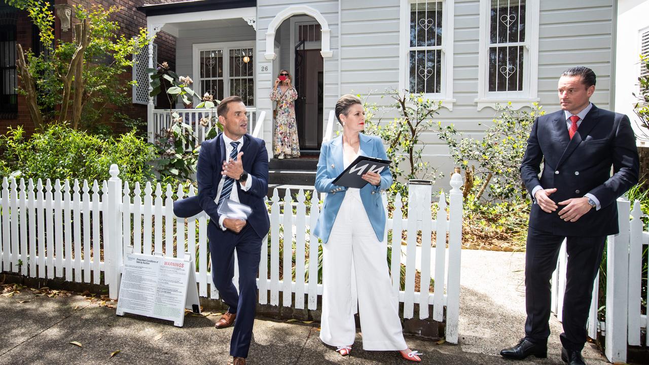 Auctioneer Paul Menck (left) calls bids on the Queens Park home. Picture: Julian Andrews