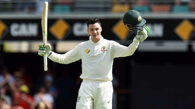 Australian batsman Peter Handscomb celebrates bringing up his century at the Gabba on Friday.