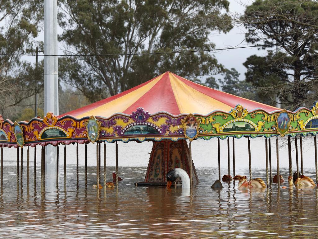 A carousel at Camden Showground is underwater. Picture: Jonathan Ng