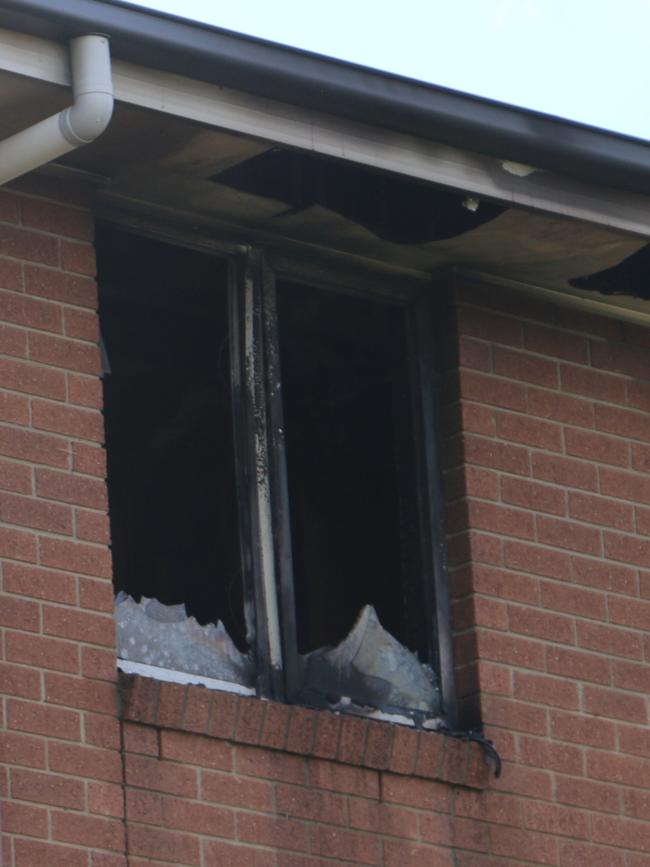 The back windows were smashed out and insulation hanging from the roof after the fire. Picture: Navarone Farrell