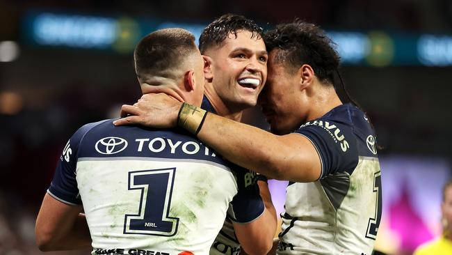 BRISBANE, AUSTRALIA - MAY 18: Braidon Burns of the Cowboys celebrates with his team mates after scoring a try during the round 11 NRL match between South Sydney Rabbitohs and North Queensland Cowboys at Suncorp Stadium, on May 18, 2024, in Brisbane, Australia. (Photo by Hannah Peters/Getty Images)