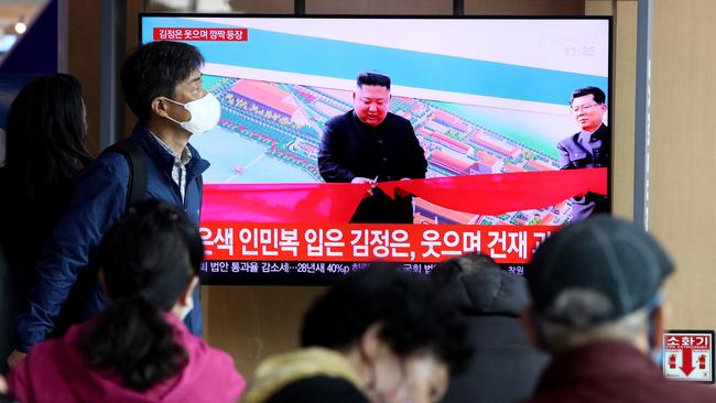 North Korean leader Kim Jong-un is seen cutting a ribbon at a factory. Picture: Getty Images