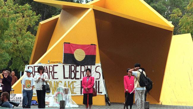 Protesters next to the sculpture in 2000.